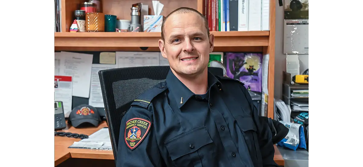 Matthew Peterson, smiling man with short dark hair in emergency services uniform.