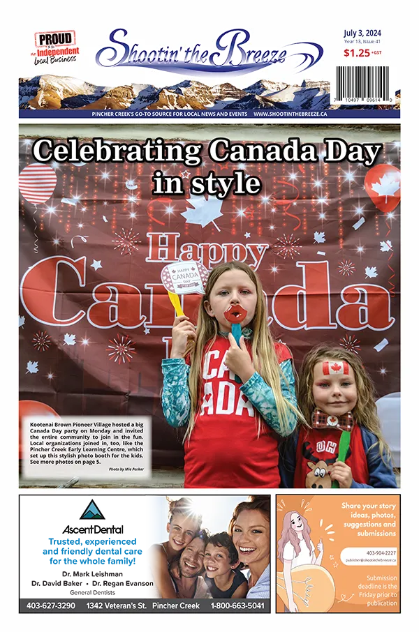 Front page of July 3, 2024, issue of Shootin' the Breeze – two young girls in Canada Day photo booth at Kootenai Brown Pioneer Village in Pincher Creek