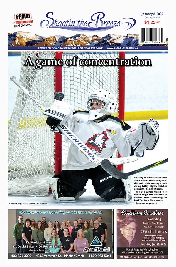 "The front page of the Jan. 11, 2025, issue of Shootin' the Breeze features Alex Kay, a young hockey goalie for the Pincher Creek U11T6 Huskies, wearing a white jersey, focuses on stopping a puck with his glove. The headline reads ""A game of concentration."" Below are ads for Ascent Dental and Blackburn Jewellers. Shootin' the Breeze is a community newspaper and website covering Pincher Creek, Crowsnest Pass and southwestern Alberta news."