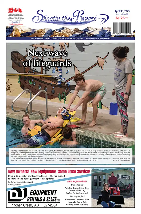 Front page of the April 30, 2025 issue of Shootin’ the Breeze. Trainee lifeguards practise a rescue scenario at the Pincher Creek Swimming Pool during a National Lifeguard course.