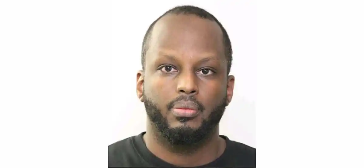 Christian Nyabirungu, 35-year-old murder suspect with black hair and beard in police mugshot photo