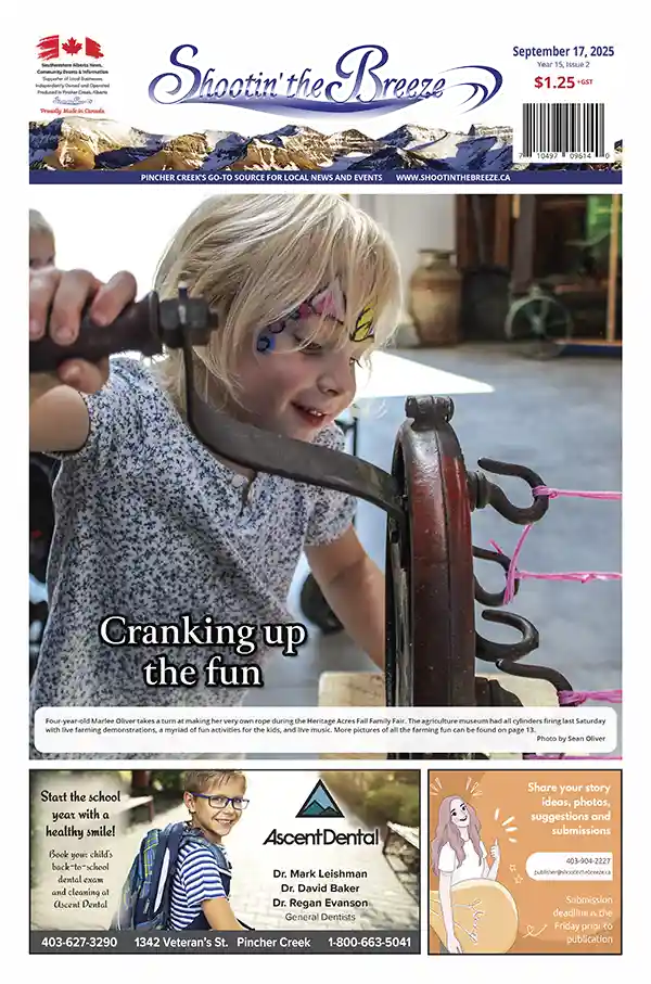 Four-year-old girl learning traditional rope-making at Heritage Acres Fall Family Fair in Pincher Creek
