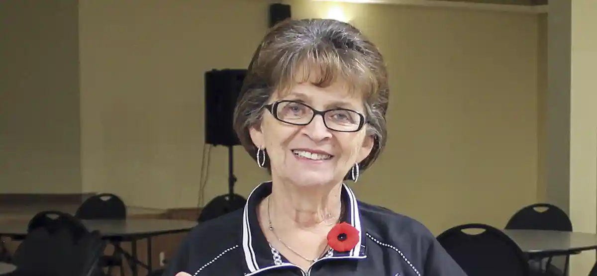 Headshot of woman with shorter brown hair and glasses